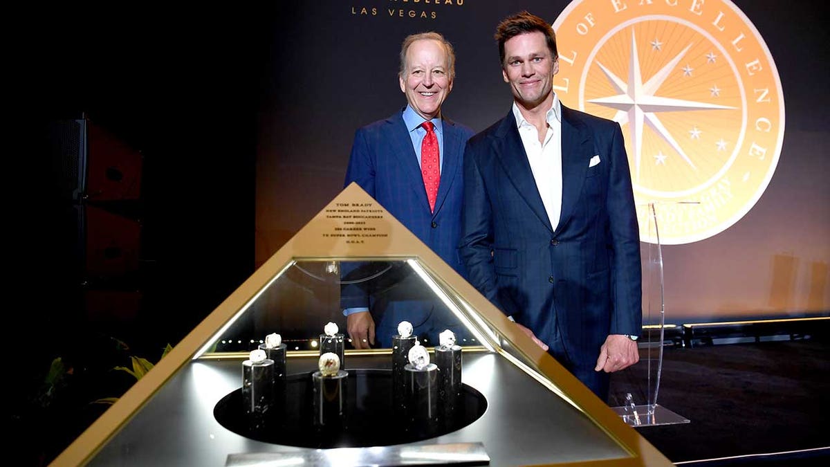 Jim Gray and Tom Brady with the rings