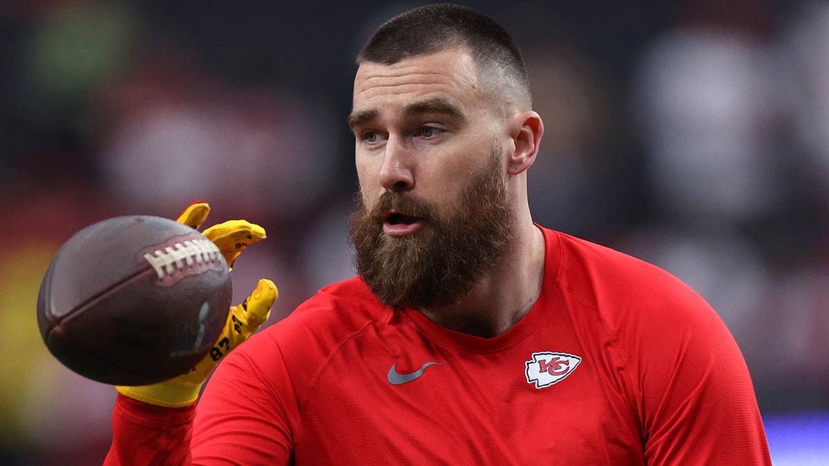 Travis Kelce catches the ball in warmups.