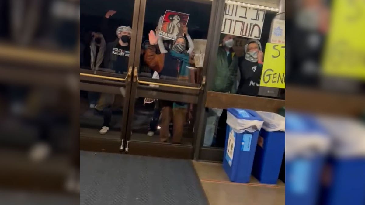 Protesters bang on glass doors of UC Berkely building