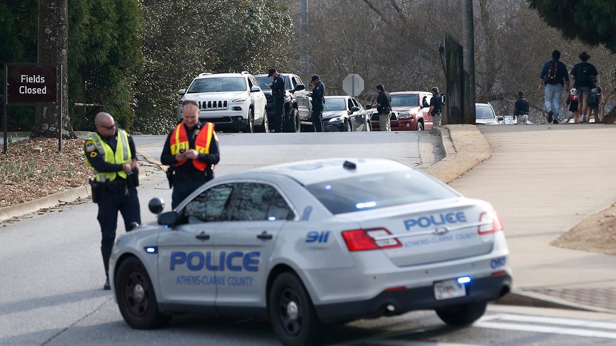Athens-Clarke County police block traffic and investigate at the UGA intramural Fields after the body of a women was found