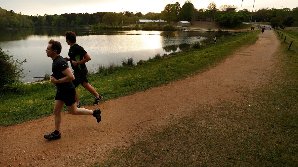 Runners take off around Lake Herrick at Oconee Forest Park in Athens, Ga