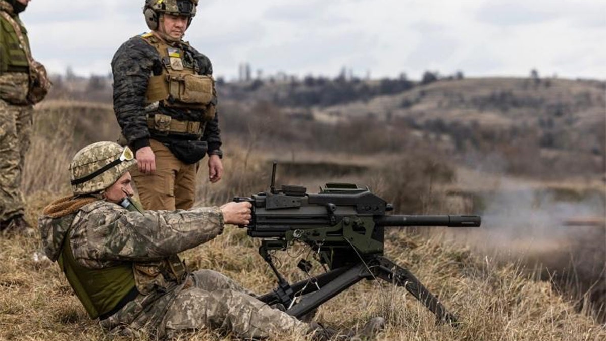 John Roberts using a machine gun.