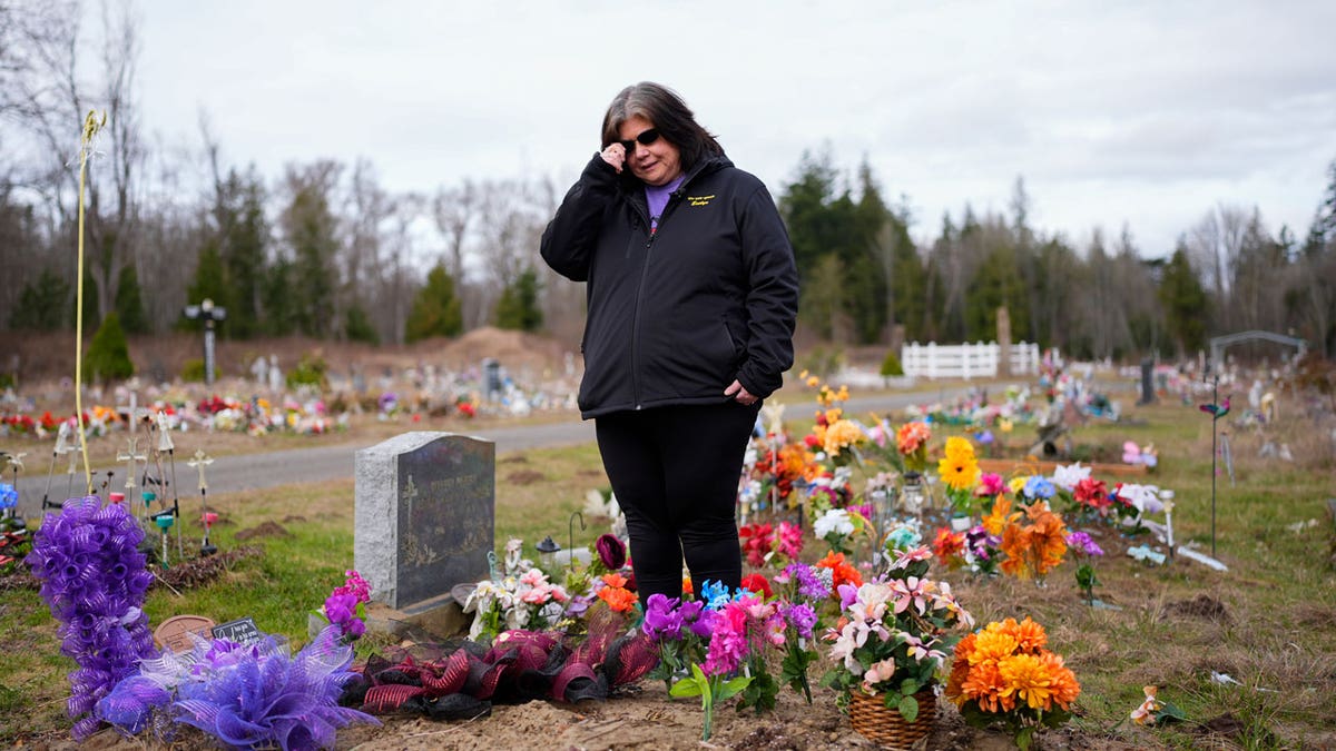 Evelyn Jefferson, a crisis outreach supervisor for Lummi Nation, stands at her son's grave