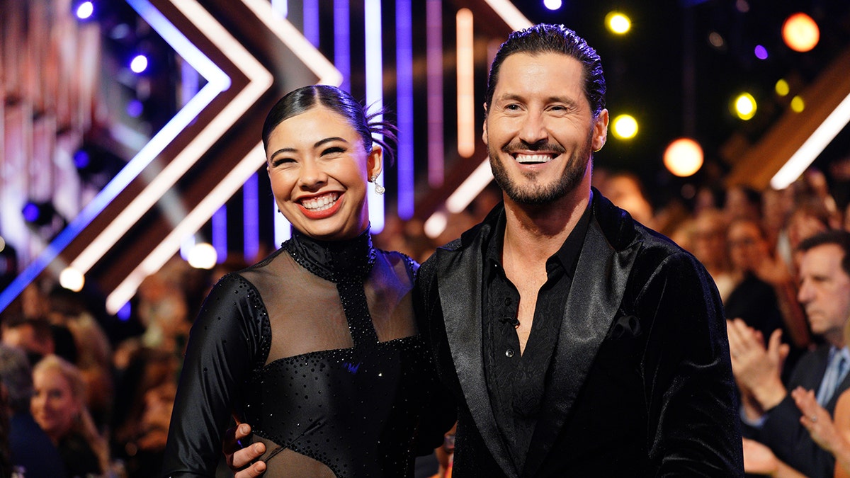 XOCHITL GOMEZ, VAL CHMERKOVSKY posing together in the Dancing with the Stars Ballroom