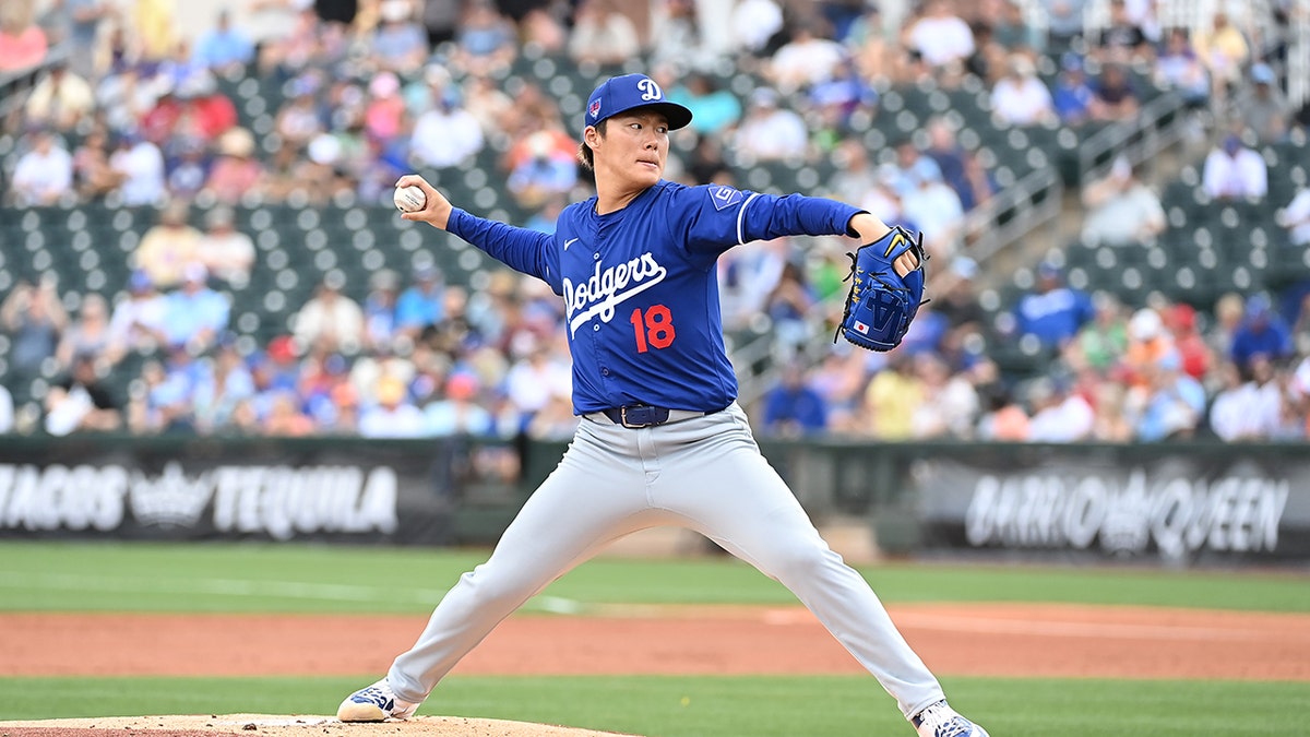 Yoshinobu Yamamoto pitches