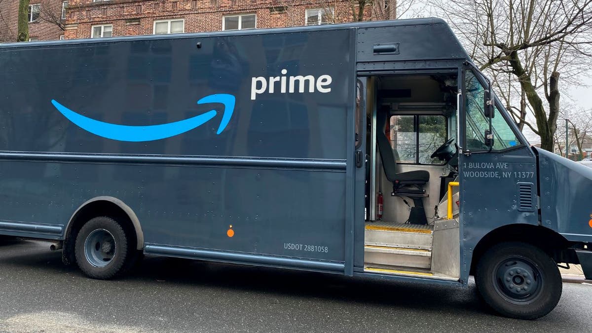 An Amazon Prime delivery van outside a residential building in New York City.