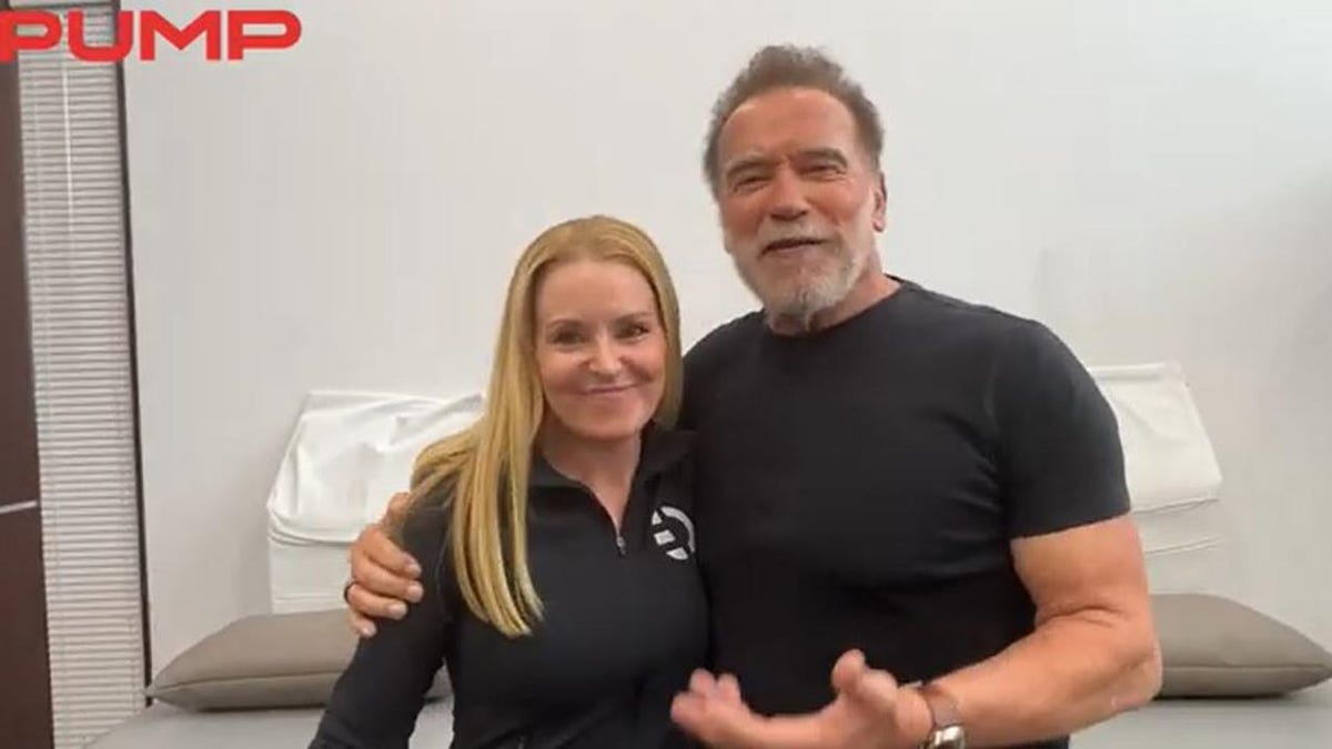Arnold Schwarzenegger with his arm around Heather milligan