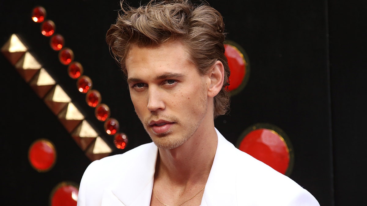 Austin Butler walks red carpet wearing white blazer