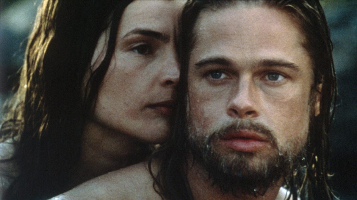 Brad Pitt with long dripping wet hair as Tristan Ludlow in "Legends of the Fall" with Julia Ormond as Susannah behind him