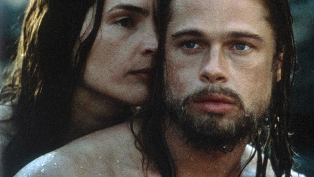 Brad Pitt with long dripping wet hair as Tristan Ludlow in "Legends of the Fall" with Julia Ormond as Susannah behind him