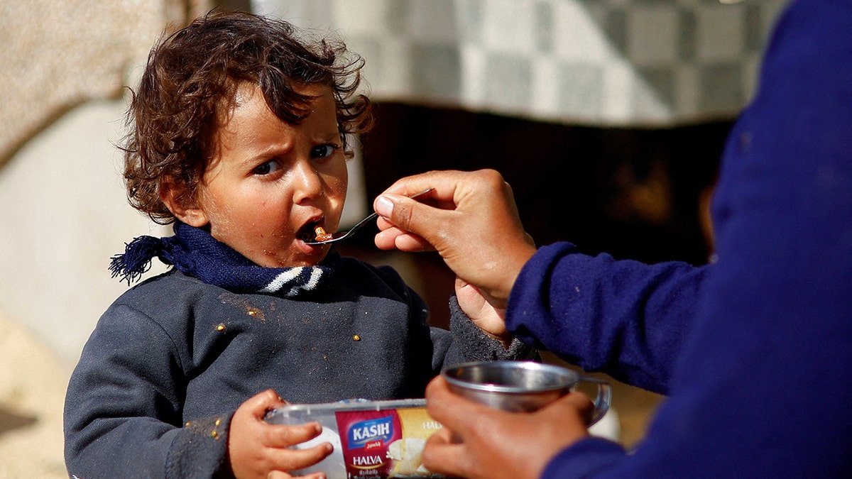 Child eating in northern Gaza