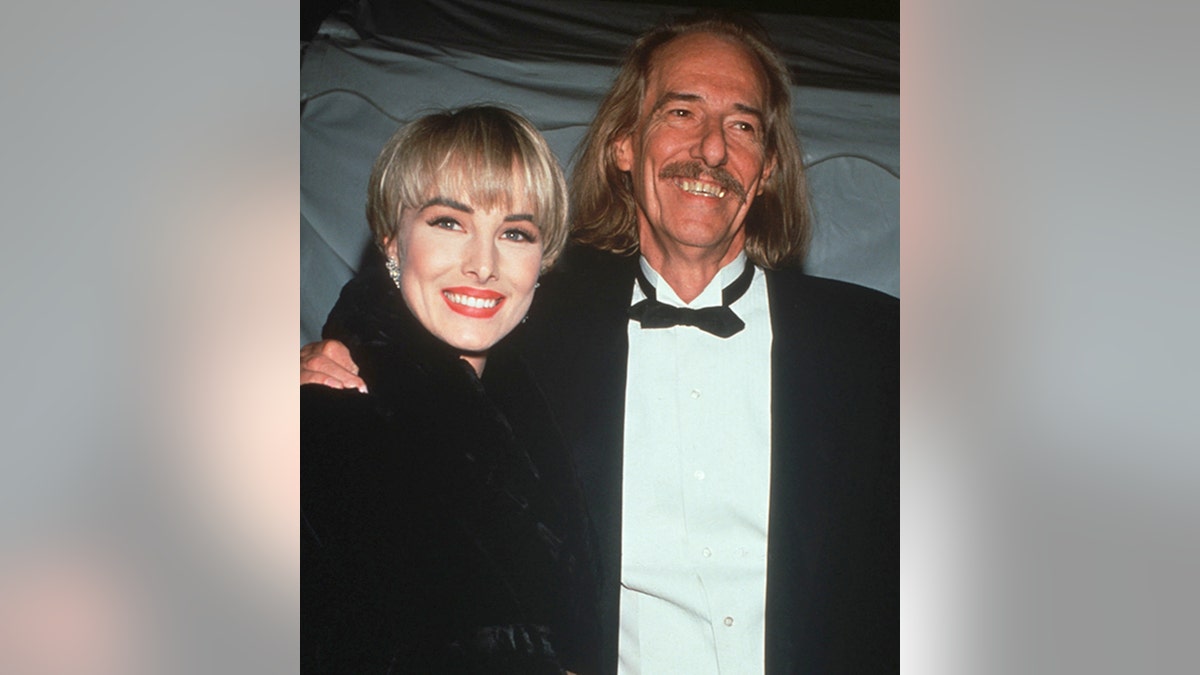 Chynna Phillips with a blonde helmut-head haircut smiles with her father the Mamas & The Papas singer John Phillips at the Grammys