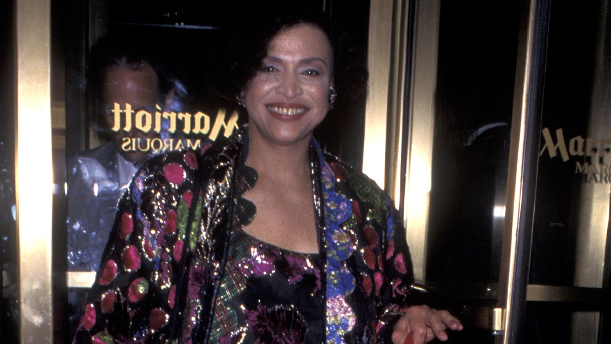 Gloria Foster in a multicolored jacket
