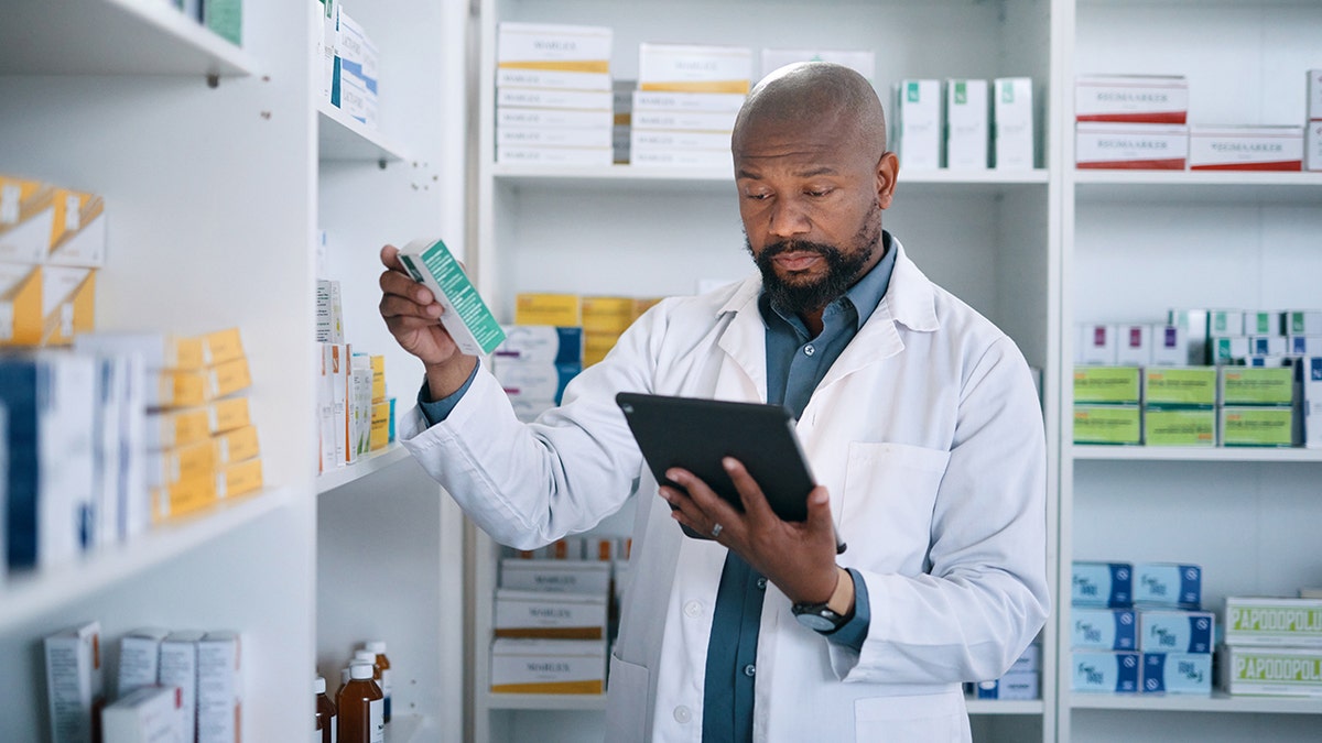 pharmacist reads drug info