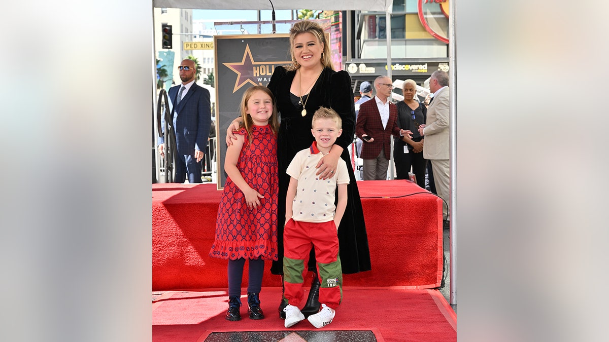 Kelly Clarkson on the walk of fame poses with her two children, River Rose and Remington Alexander