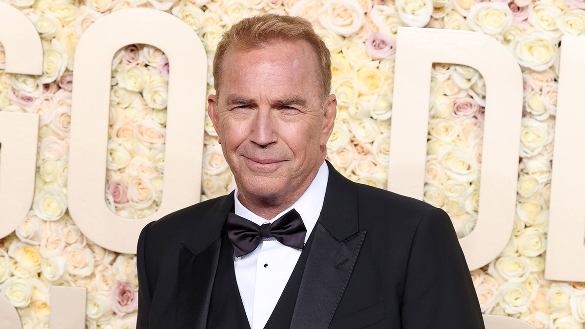 Kevin Costner wears a black tuxedo on red carpet