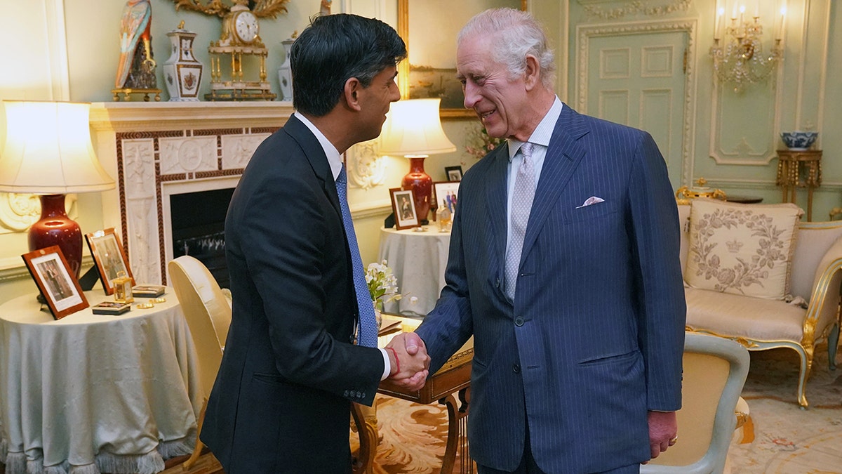 King Charles shakes prime minister's hand at the palace