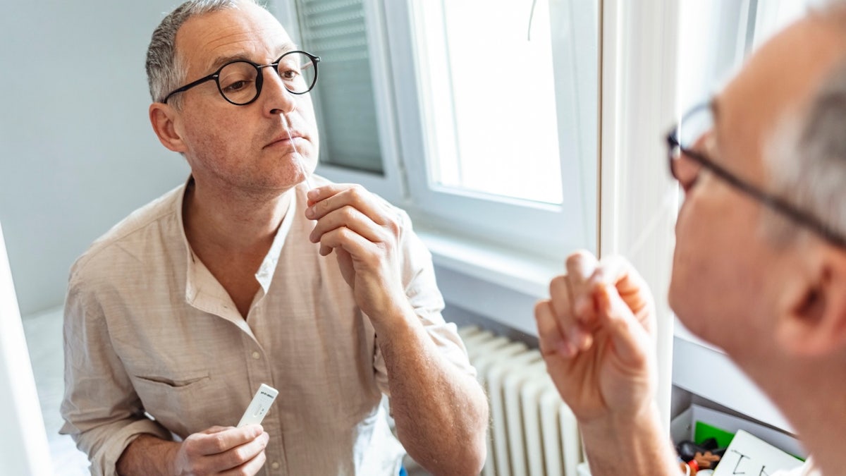 Man giving COVID test