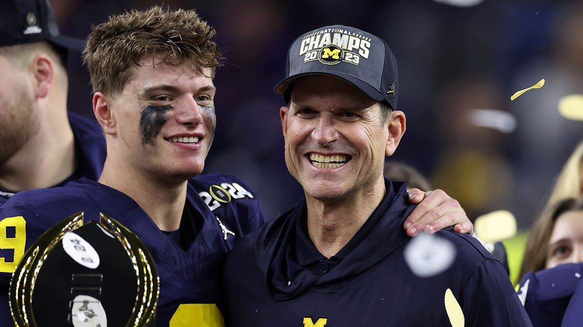 JJ McCathy and Jim Harbaugh after winning title