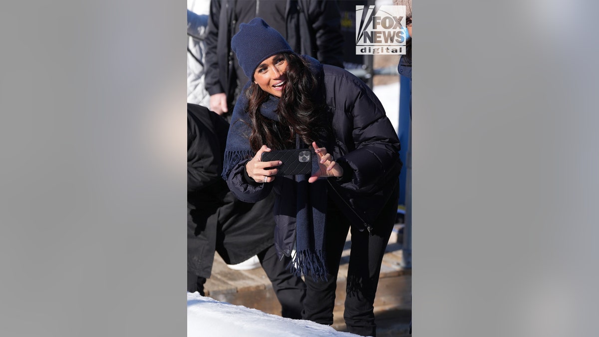 Meghan Markle filming with her phone