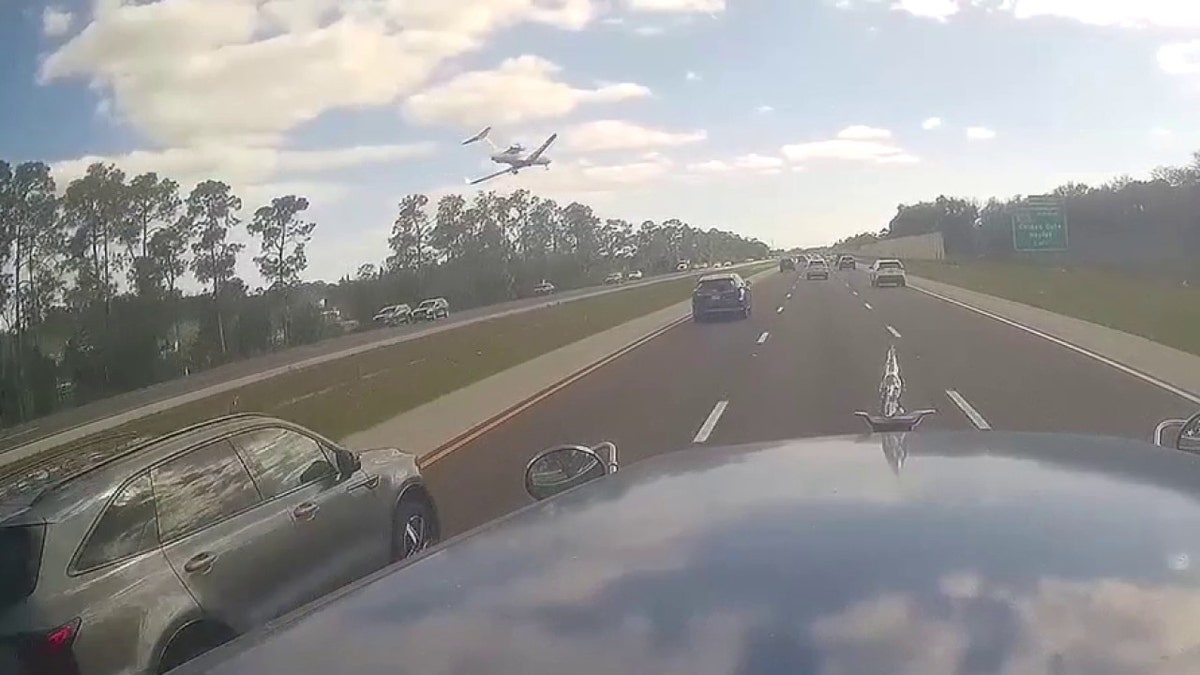 plane flying low over I-75