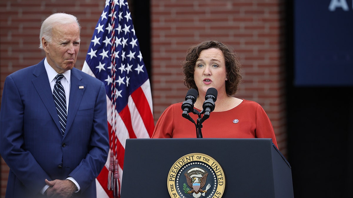 President Biden stands next to Rep. Katie Porter as she speaks