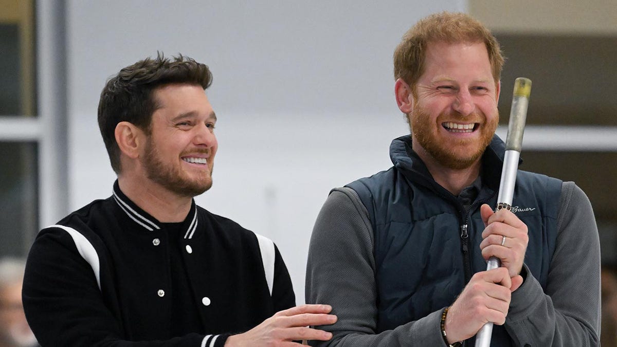 Michael Bublé smiling with Prince Harry