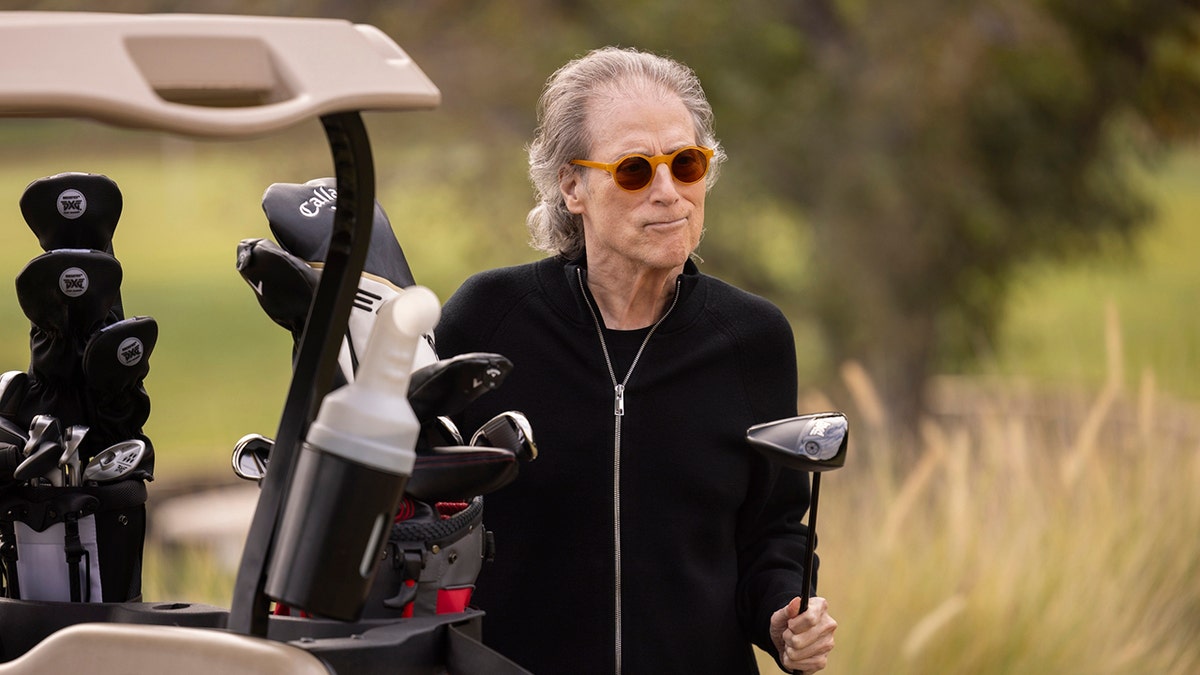Richard Lewis holding a golf club in a scene from Curb Your Enthusiasm