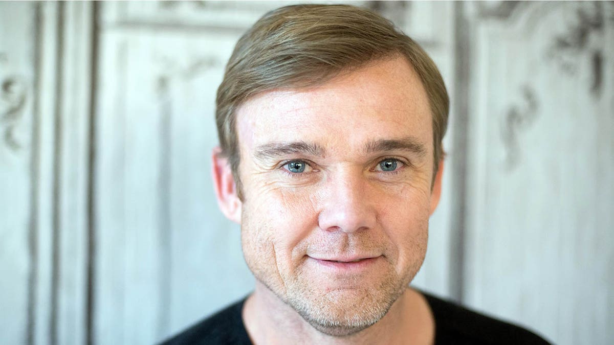 ricky schroder closeup smiling against a white background