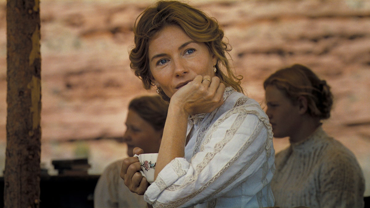 Sienna Miller sits on the set of Kevin Costner's country movie Horizon