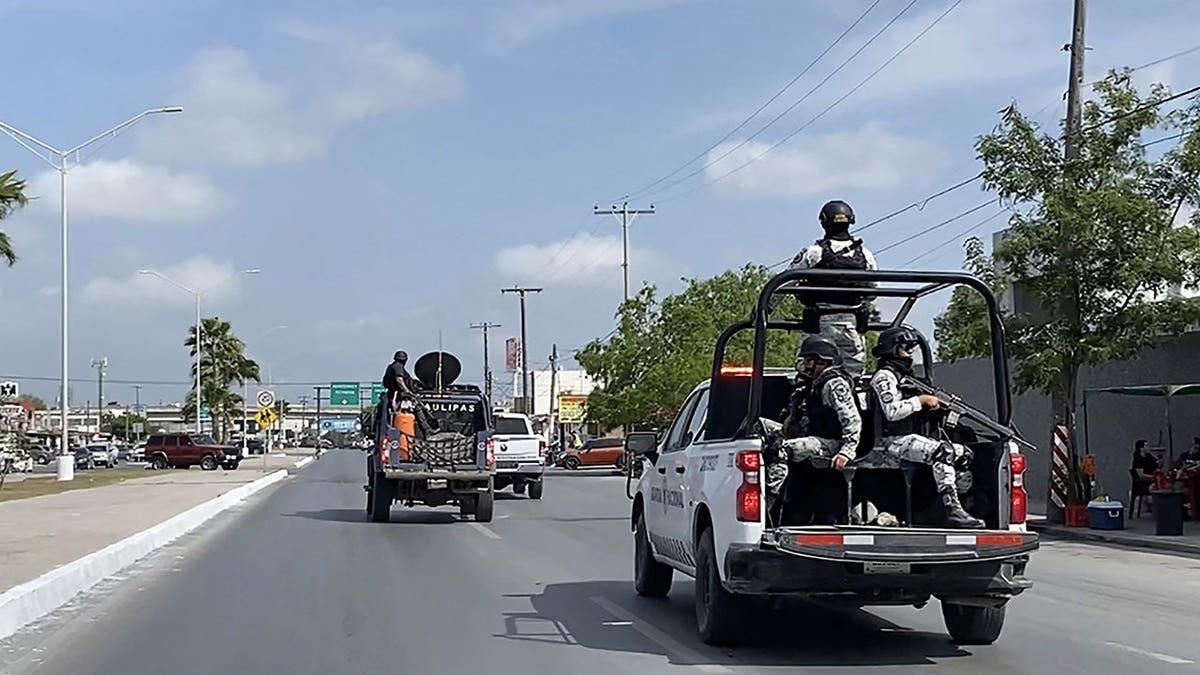 Mexican National Guard ride in cars