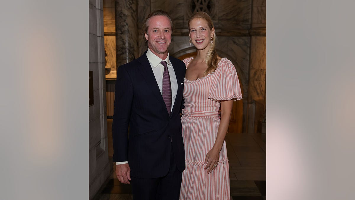 Thomas Kingston in a black suit poses next to wife Lady Gabriella in a pink dress