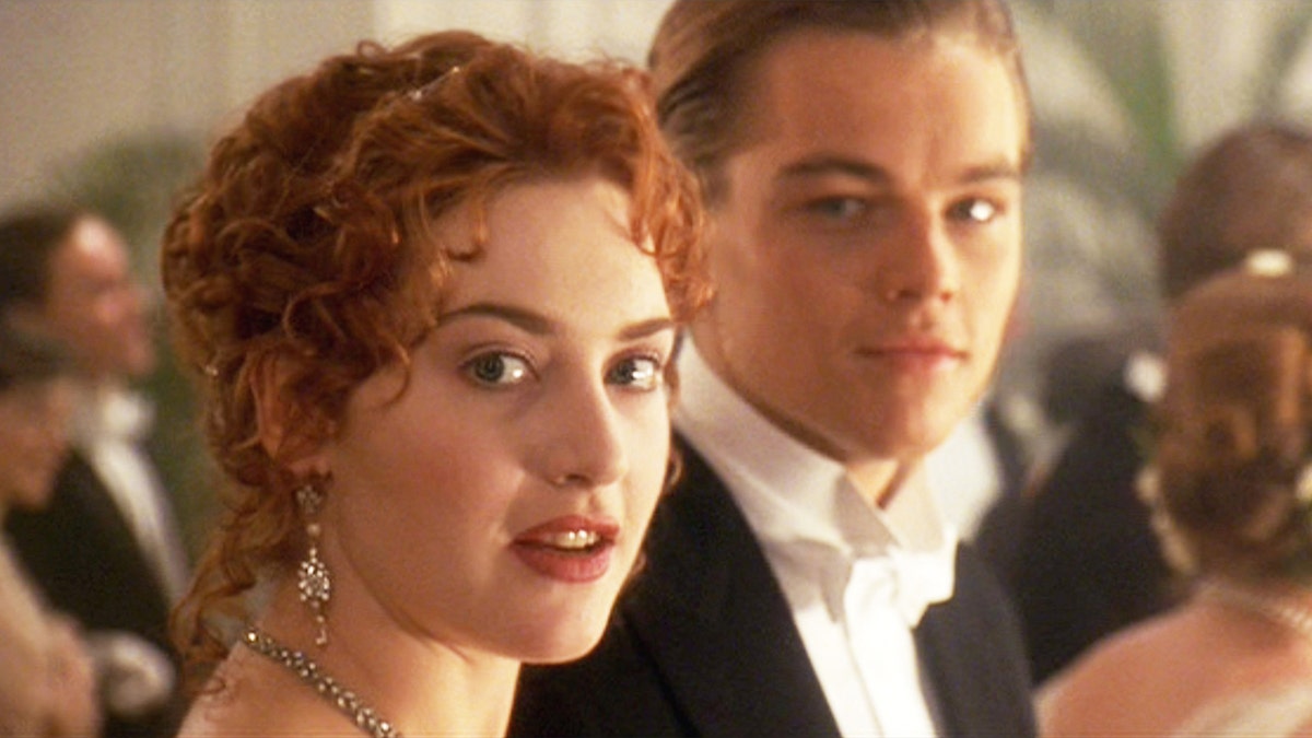 Kate Winslet with red hair in the "Titanic" as Rose looks at the camera as Leonardo DiCaprio, who played Jack stares at her