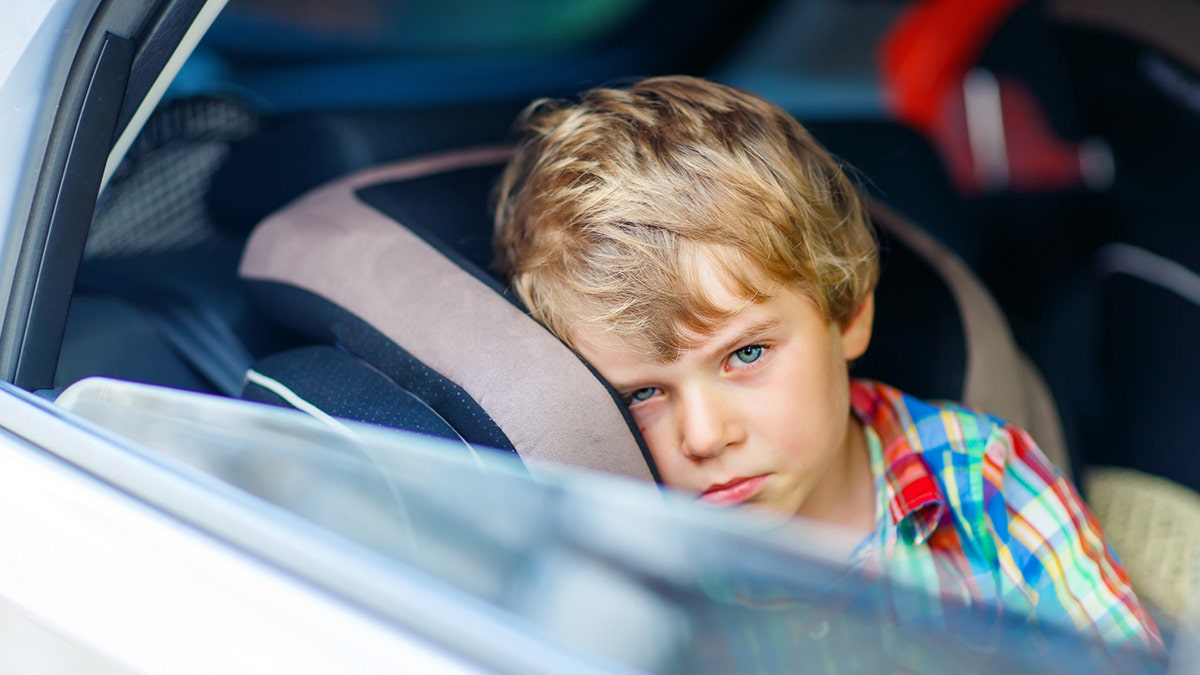 Sad toddler in the car