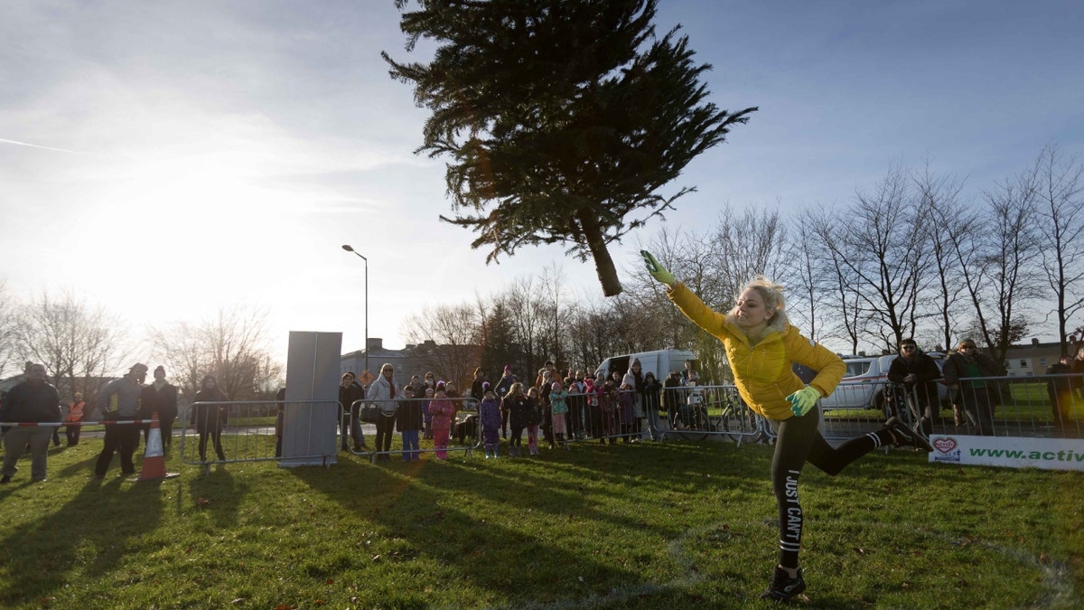 Woman throws Christmas tree