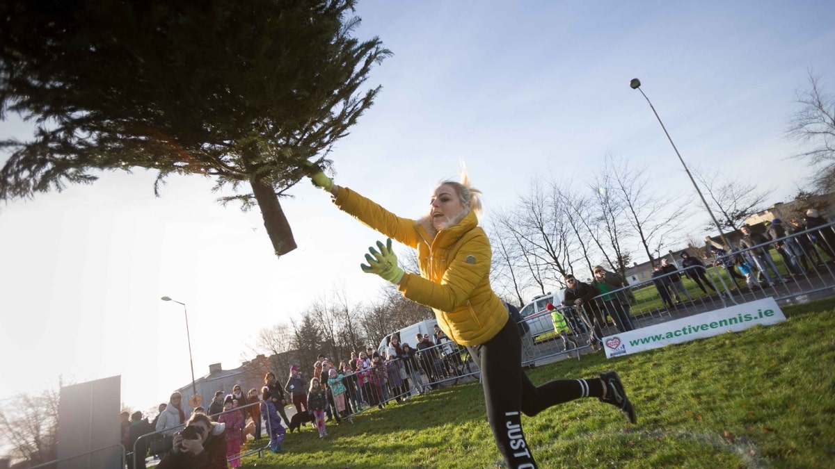 Woman throws Christmas tree