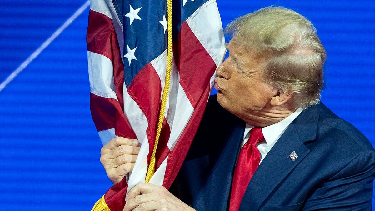 Donald Trump kissing American flag