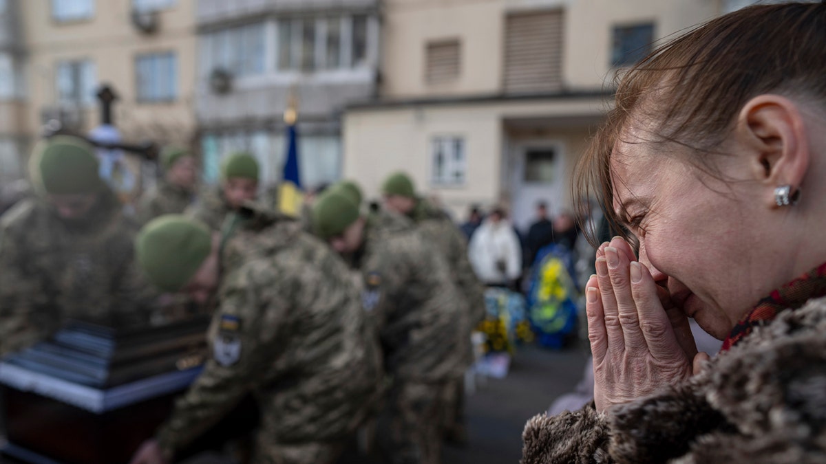A woman crying at a Ukrainian lieutenants funeral