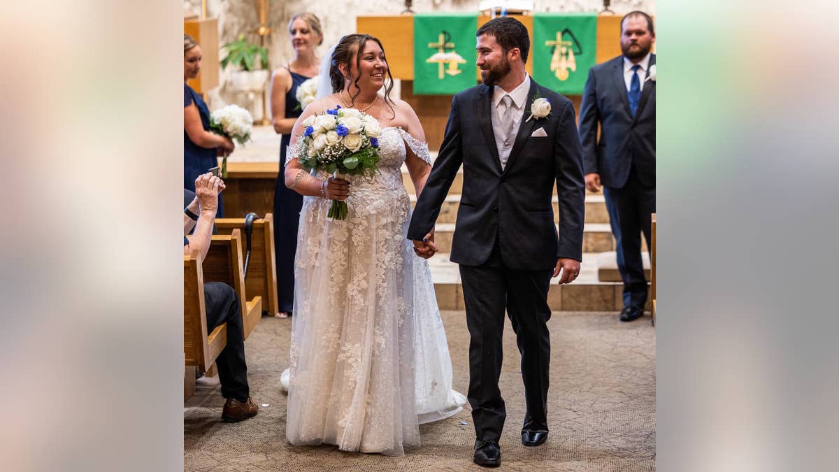 Gina and Emerson Weingart walking down the aisle during the June 2023 wedding.