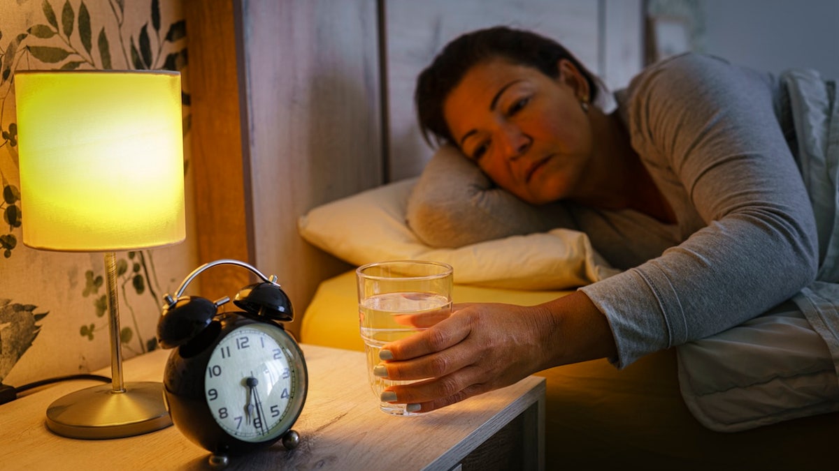 Woman drinking in bed