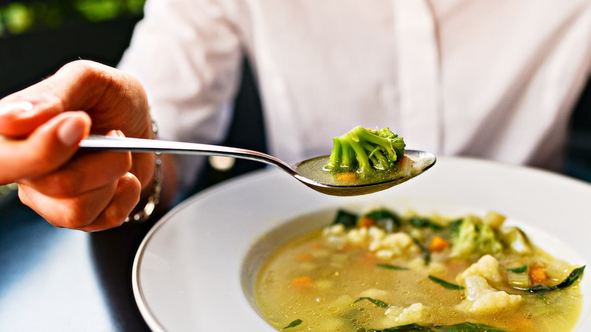 Woman eating soup