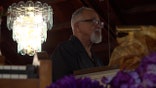 Pastor Reginald Landry preaches to his congregation at the head of the church