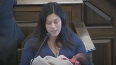 New Hampshire Democrat cradles newborn daughter while advocating for abortion rights during floor debate