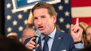 Democratic presidential candidate Dean Phillips said Friday that he laid off "a lot" of his campaign staff as he vowed to stay in the race against incumbent President Biden.