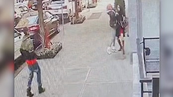 Doorman saves woman from broad daylight robbery as onlookers do nothing and suspects run away laughing