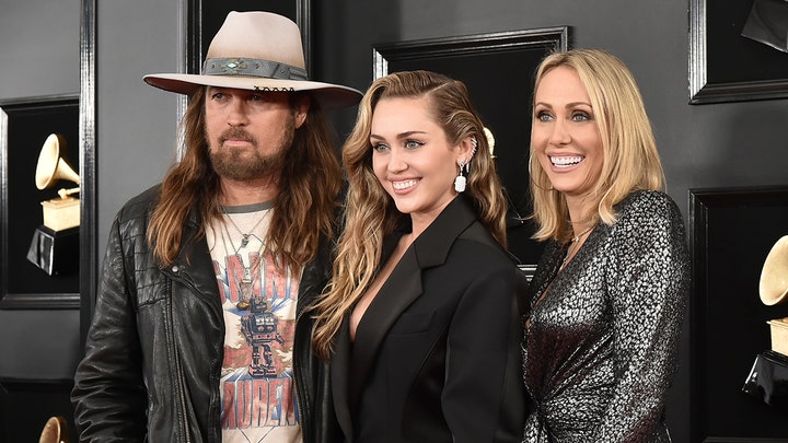 Miley Cyrus walks the red carpet at the Grammys in gold