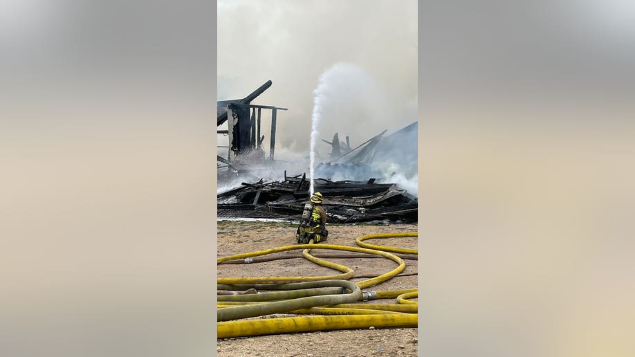 Firefighter sprays collapsed structure