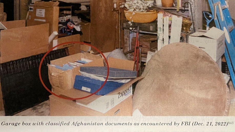 Files in torn cardboard box in disorganized garage