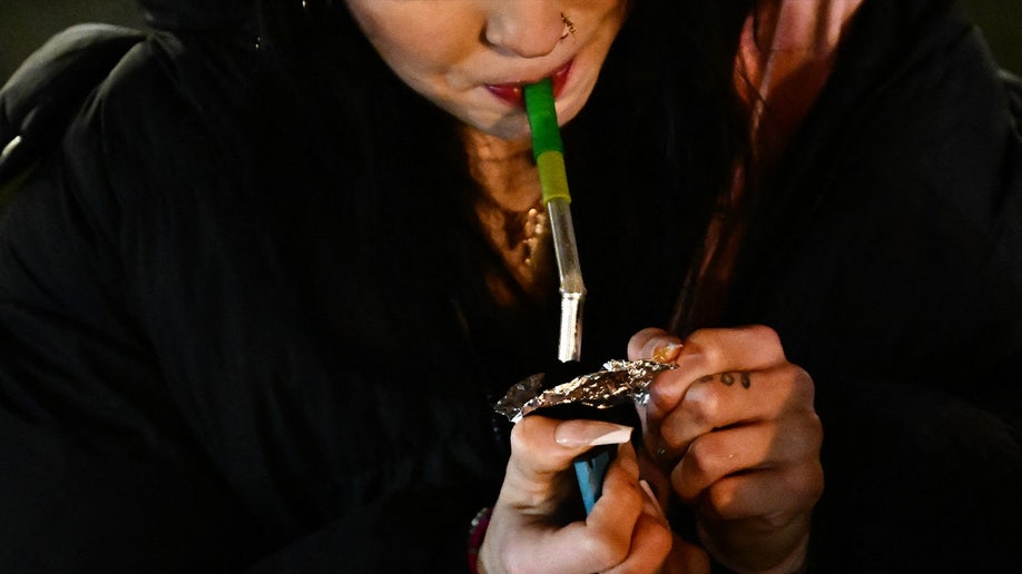 Woman smokes fentanyl at night in Portland