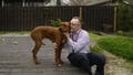 Chaplain Matthew Sullivan spends time with his dog Hank after coming home from work at The Covenant School Friday, March 22, 2024, in Nashville, Tenn. Nearly a year after a shooting at the christian elementary school that left six dead, many of the school's families have adopted dogs in dealing with their shared suffering.
